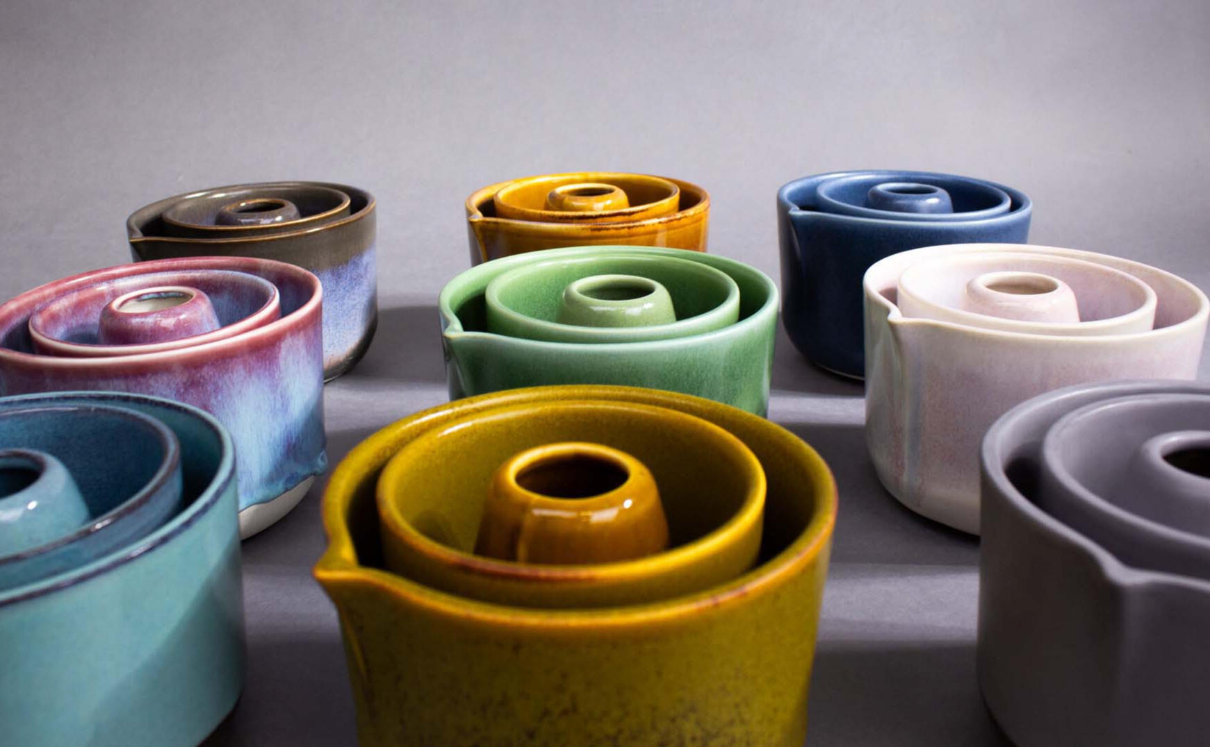 Assorted slipcast porcelain vessels in multiple glaze colors